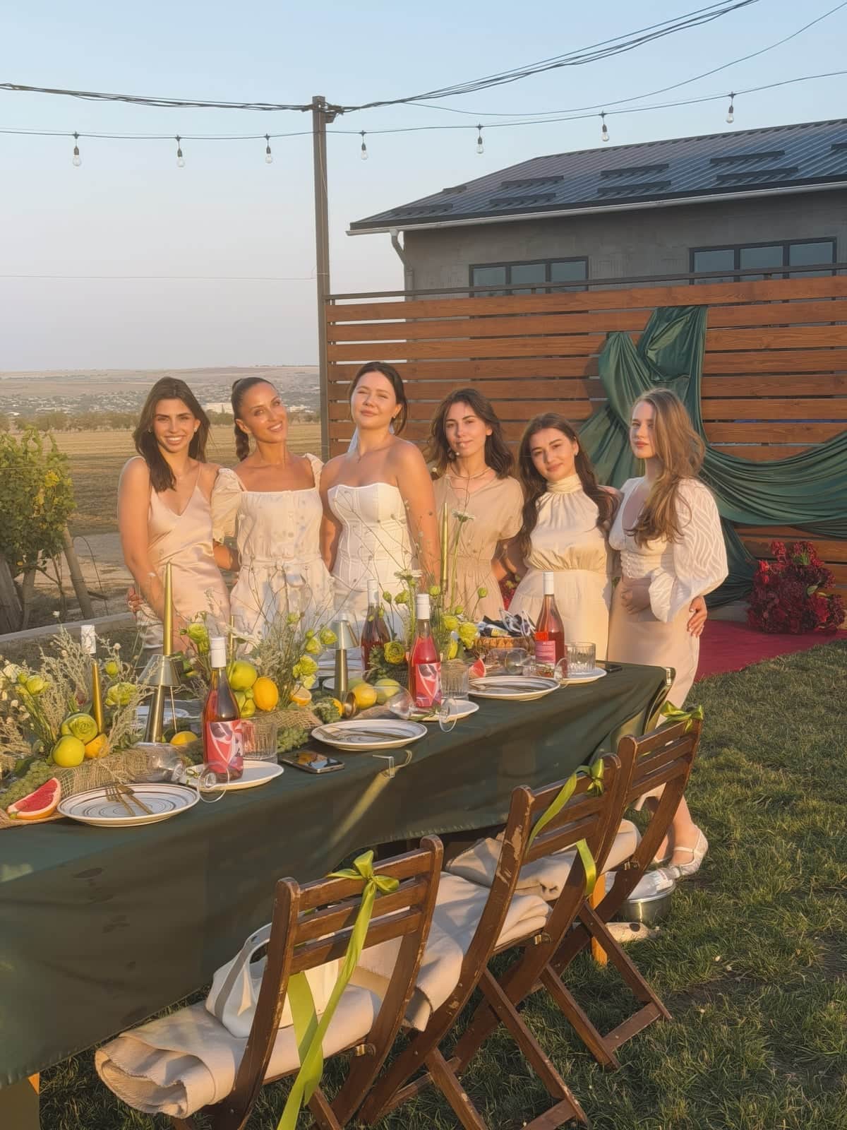 A hen party at a long table at sunset